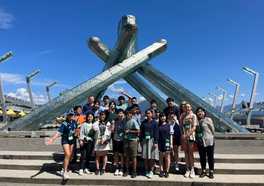 A group of students in front of a famous Vancouver statue